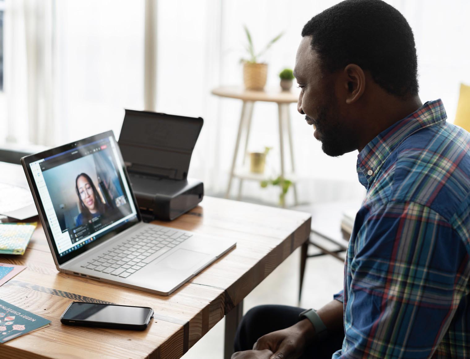 A man watching a virtual event on his laptop at home